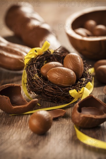 Assorted chocolate eggs for Easter on wooden background