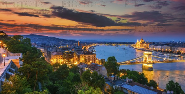 Panoramic view of Budapest with Hungarian Parliament Building on the bank of the Danube and Chain Bridge by night