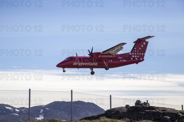 Ilulissat, Greenland, June 30, 2018: A Bombardier Dash 8 Q200 aircraft operated by Air Greenland landing at the airport, North America