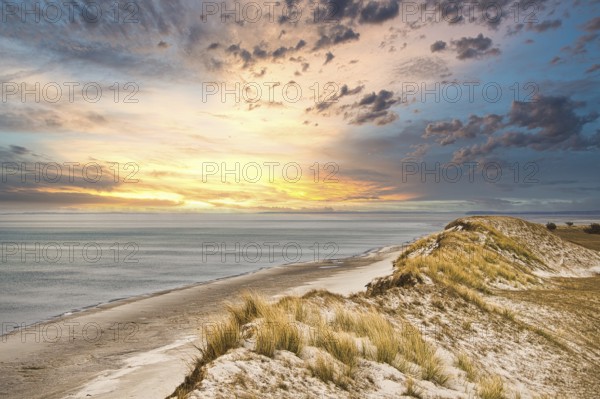 Dramatic sunset at the high dune on the darss. Viewpoint in the national park. Beach, Baltic Sea, sky and sea. Nature shot in Germany