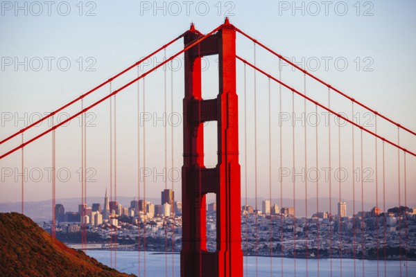 A view at dusk thru the Golden Gate Bridge towards downtown San Francisco. In California, USA, North America