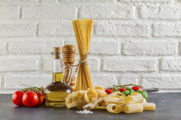 Surface with different types pasta tomatoes oil