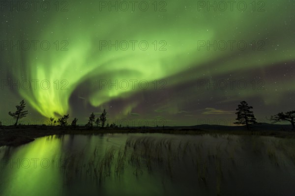 Northern Lights (Aurora borealis) reflected in a mountain lake, Gällivare, Norrbotten, Lapland, Sweden, October 2013, Europe