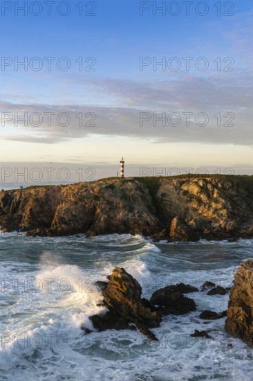view of the rugged Alentejo coastline and Porto Covo lighthouse at sunset