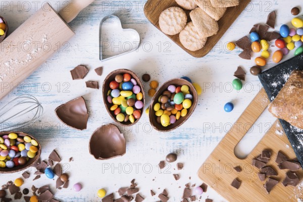 Chocolate eggs with candies near pastry