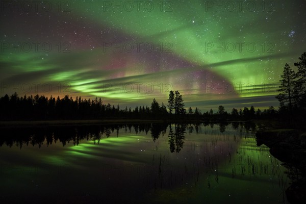 Northern lights reflected in a lake, Norrbotten, Lapland, Sweden, September 2014, Europe