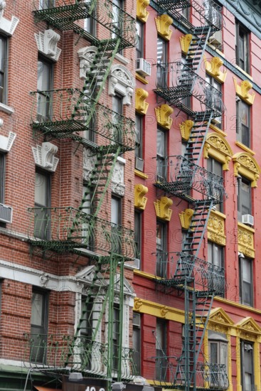 Colourful fire escape on the rustically decorated building facade, Manhattan, New York City, New York, USA, North America