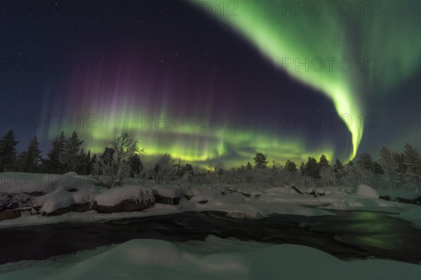 Northern Lights (Aurora borealis) over a moonlit winter landscape, Norrbotten, Lapland, Sweden, January 2017, Europe