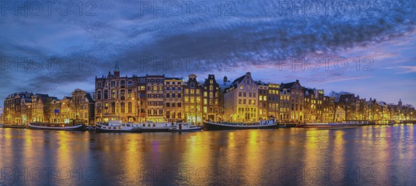 Amsterdam Netherlands, night panorama city skyline of Dutch house at canal waterfront