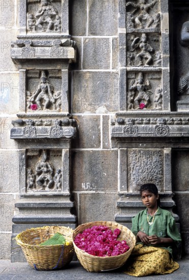 A girl selling flowers passageway of east gopuram in Thillai Nataraja temple in Chidambaram, Tamil Nadu, South India, India, Asia