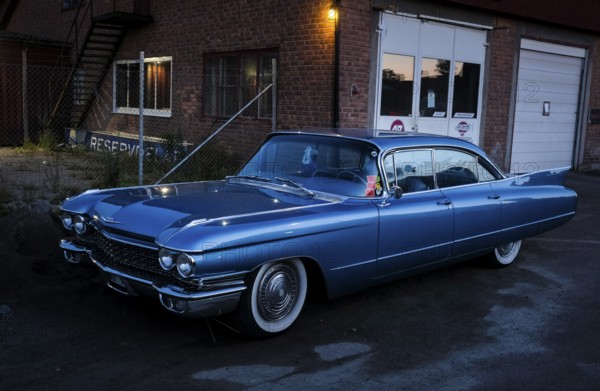 American classic car, blue Cadillac in front of red brick building, industrial area, night shot, Rättvik, Dalarna, Sweden, Europe