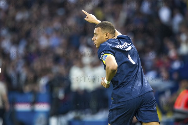 Football match, captain Kylian Mbappe' Paris St Germain has just scored 1-0 for Paris St Germain, right finger up signalling his goal, captain's armband, Parc des Princes football stadium, Paris, France, Europe