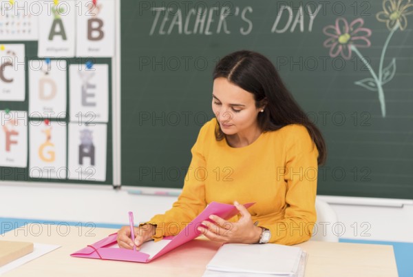Teacher taking notes class
