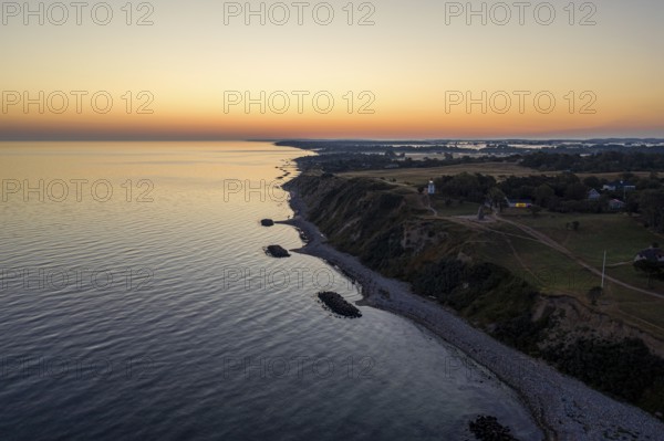 Hundested, Denmark, August 15, 2020: Aerial drone view of Spodsbjerg lighthouse and the coastline during sunrise, Europe