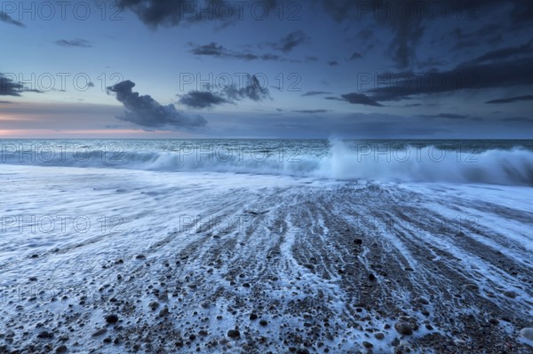 Ocean waves in dusk with long exposure, Normandy, France, Europe