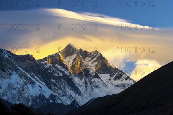 South Face of the eight-thousander Lhotse, with a lenticular cloud above its summits, viewed at sunrise from Pangboche. The Everest Region, Khumbu Region. The Himalayas. Sagarmatha National Park, a UNESCO World Heritage Site. Solukhumbu, Nepal, Asia