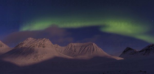 Northern Lights (Aurora borealis) over moonlit mountains in the valley Stuor Reaiddavaggi, Kebnekaisefjaell, Norrbotten, Lapland, Sweden, March 2013, Europe