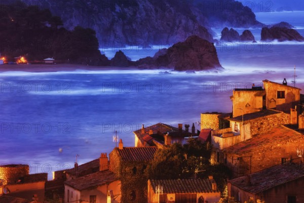 Old coastal town of Tossa de Mar at dusk on Mediterranean Sea, view over historic houses of Vila Vella, Costa Brava, Catalonia, Spain, Europe