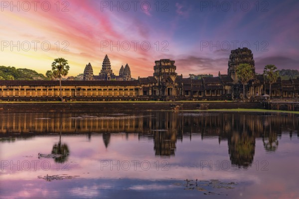 Panorama of Angkor Wat temple reflecting in water at sunset near Siem Reap, Cambodia, Asia