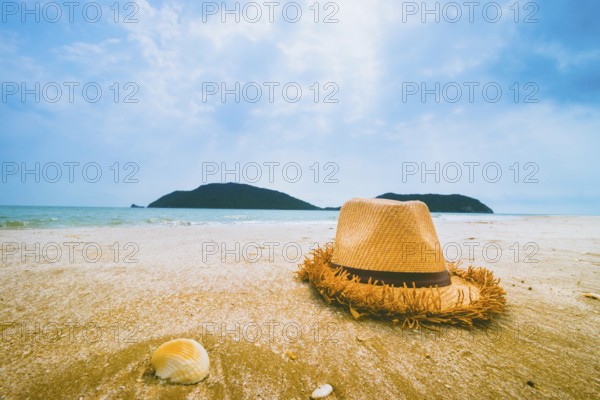 Hat and Shell on tropical beach