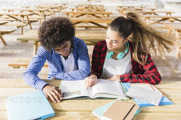 Elevated view university students reading books classroom