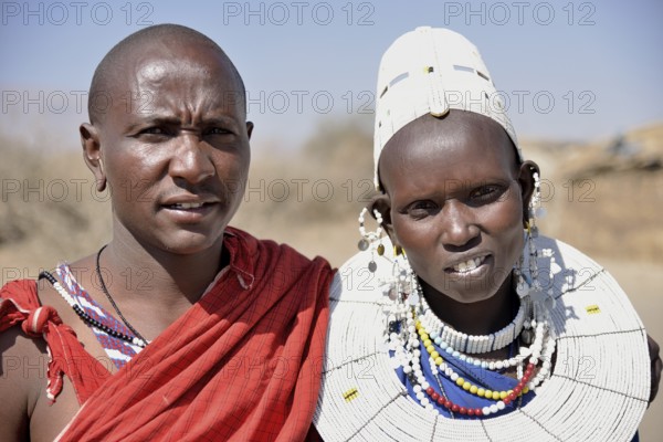 Maasai man and a woman wearing traditional dress, Ngorongoro Conservation Area, Ndema, Tanzania, Africa