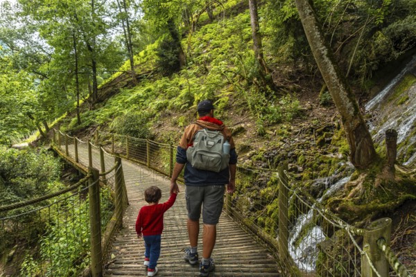 Father and son on a mountain trail in the Borce commune of the French Pyrenees