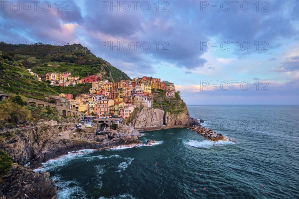 Manarola village popular european italian tourist destination in Cinque Terre National Park UNESCO World Heritage Site, Liguria, Italy on sunset