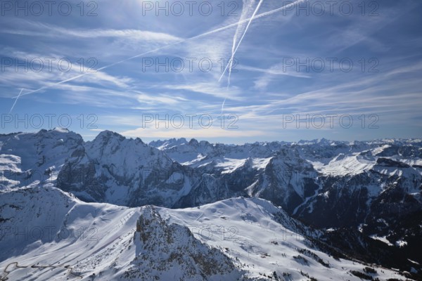 View of a ski resort piste and Dolomites mountains in Italy from Passo Pordoi pass. Arabba, Italy, Europe