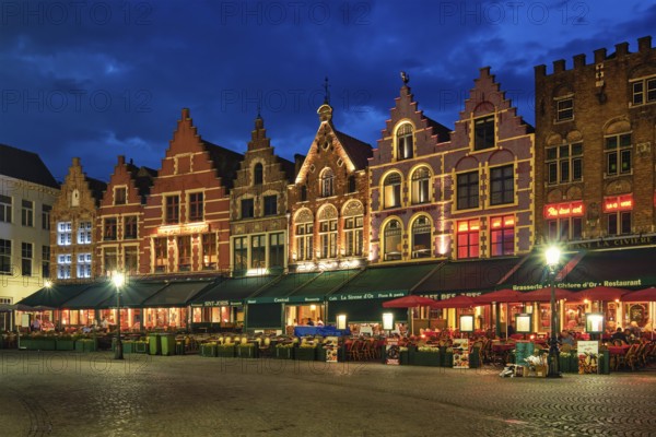 Bruges, Belgium, May 29, 2018: Bruges Grote markt square famous tourist place with many cafe and restaurants in the evening night twilight, Europe
