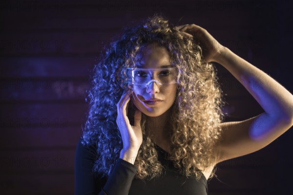 Beauty sensual woman using smart glasses in an urban space
