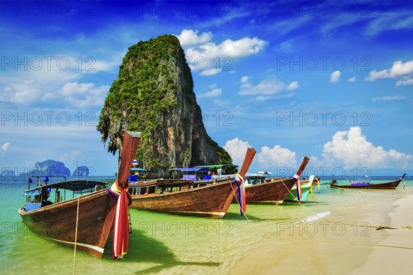 Long tail boat on tropical beach with limestone rock, Krabi, Thailand, Asia