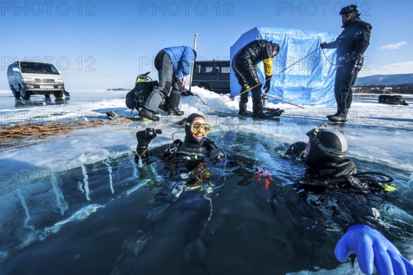 Scuba divers after an ice dive, Lake Baikal, Pribaikalsky National Park, Irkutsk Province, Siberia, Russia, Europe