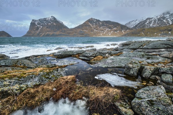 Rocky coast of fjord of Norwegian sea in winter. Lofoten islands, Norway, Europe