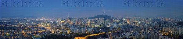 Panorama of Seoul downtown cityscape illuminated with lights and Namsan Seoul Tower in the evening view from Inwang mountain. Seoul, South Korea, Asia