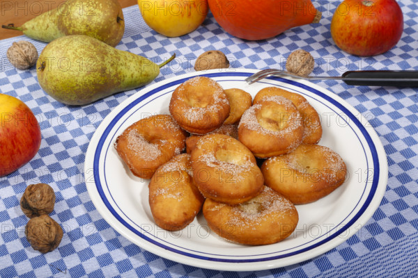 Swabian cuisine, harvest cakes, dessert, dessert, fat baked goods, doughnuts, fried food, lard noodles, arranged on a plate, grandmother's kitchen, regional, home cooking, typical Swabian, classic recipe, traditional cuisine, food photography, autumn atmosphere, apples, pears, nuts, still life, studio, Germany, Europe