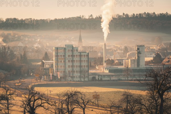 Industrial building in morning haze, smoke from chimney, Althengstett, district of Calw, Germany, Europe