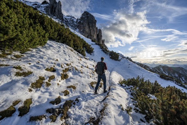 Hikers on a hiking trail with snow, ascent to Kramerspitz, in autumn, Ammergau Alps, Bavarian Prealps, Bavaria, Germany, Europe