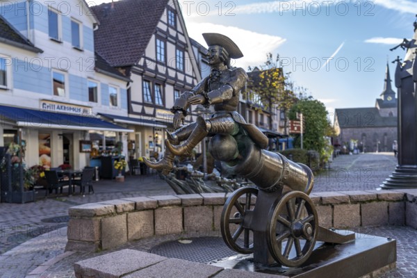 Munchausen figure The ride on the cannonball at the Munchausen fountain in Bodenwerder, Lower Saxony, Germany, Europe