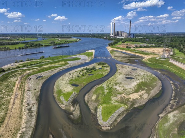 Dinslaken, Voerde, North Rhine-Westphalia, Germany, Renaturalisation of the Emscher. New Emscher estuary into the Rhine. Flood protection through land expansion. The decommissioned STEAG coal-fired power station in Voerde in the background. The mouth of the Emscher into the Rhine was moved from Dinslaken to Voerde, almost 500 metres to the north. Fish can now swim barrier-free up the new Emscher from the Rhine through a newly created floodplain area. Following the construction of a parallel sewer, the Emscher has been completely free of sewage since January 2022. The river was previously an open, above-ground combined sewer with rainwater and wastewater, Europe