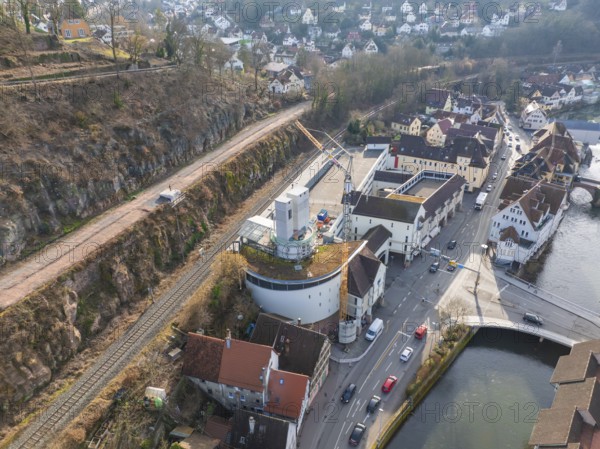 Panorama of a town with river and streets, in the foreground a building site with crane, stairway extension to the new tower of the Calw railway station on the new track of the Hermann Hessebahn, Calw, Black Forest, Germany, Europe
