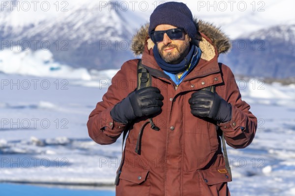 Portrait of a hiker on the frozen lake of Jokulsarlon glacier in Iceland