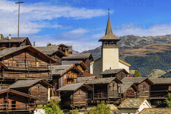Old wooden houses and the Saint Theodule church in the historic village centre, Grimentz, Val d'Anniviers, Valais Alps, Canton Valais, Switzerland, Europe