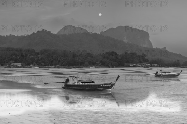 Before sunrise, longtail boats lie at low tide in the harbour at Sivalai Beach, Koh Mook Island, Satun Province, Southern Thailand, Thailand, Asia