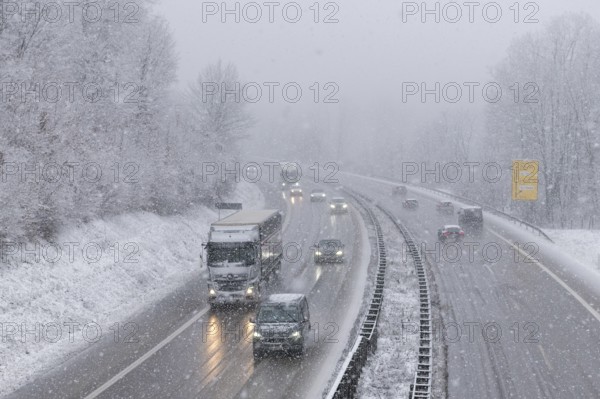 Traffic on a snow-covered motorway with passing vehicles in a wintry landscape, Winnenden, Baden-Württemberg, Germany, Europe
