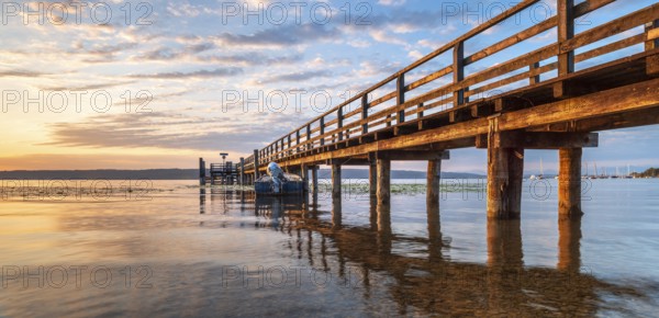 Morning atmosphere at the Lake Ammer, jetty in the first morning light, near Riederau, Bavaria, Germany, Europe