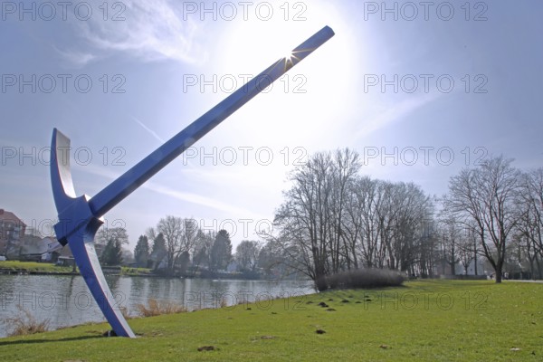 Sculpture Pickaxe by Claes Oldenburg 1982, documenta 7, backlight, XXL, oversize, very, large, pick, pickaxe, tool, garden tool, Fulda, river, bank, bridge, Karlsaue, Kassel, Hesse, Germany, Europe
