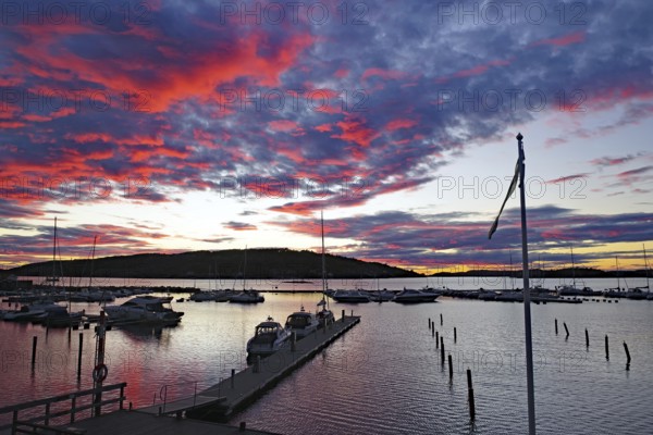 Evening glow with luminous clouds, small harbour with leisure boats, Fjällbacka, Bohuslän, Sweden, Europe