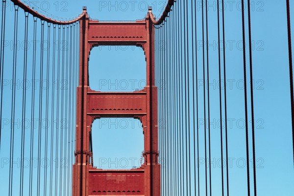 Orange pylon and steel cables of the suspension bridge, detail, Golden Gate Bridge, blue sky, San Francisco, California, USA, North America