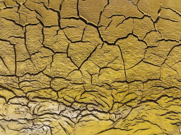 Mineral-rich cracked earth at the bank of the Rio Tinto (Red river), aerial view, drone shot, Huelva province, Andalusia, Spain, Europe
